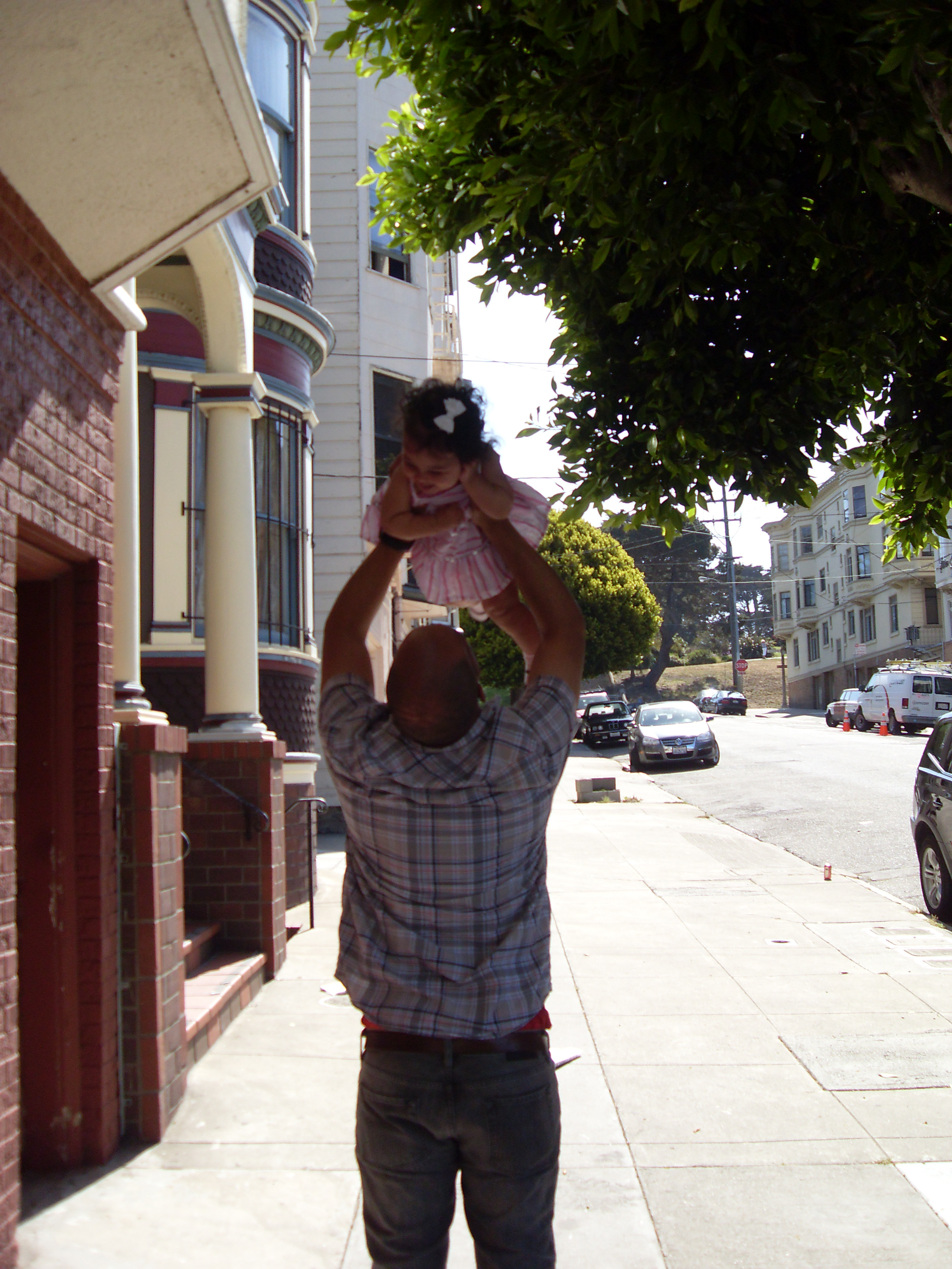 Dad holding baby overhead
