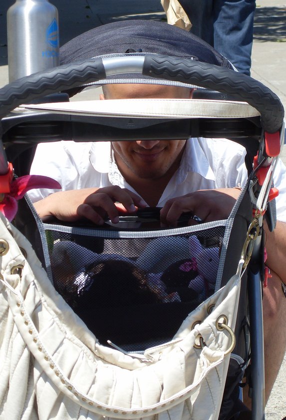 Father looking at baby in a stroller