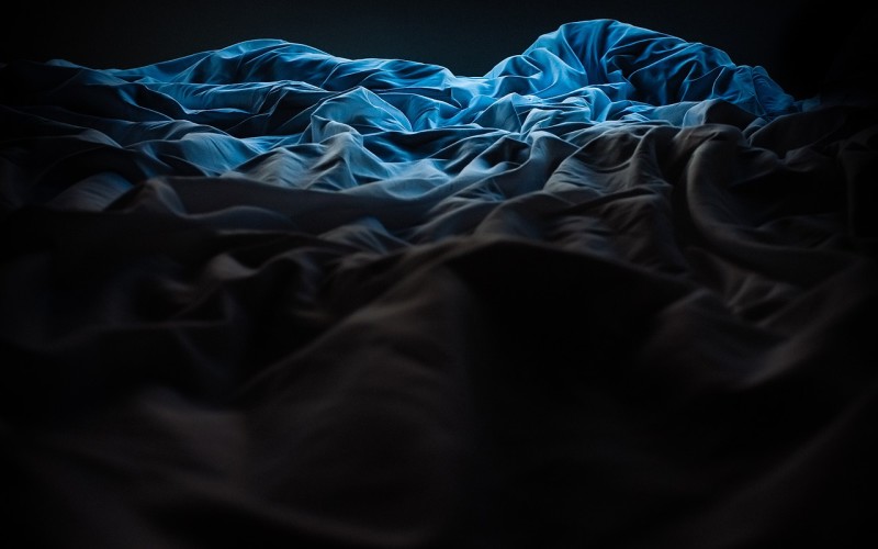 bed with rumpled sheets