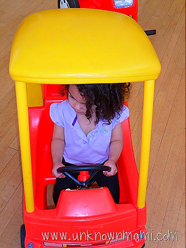 Little girl driving toy car
