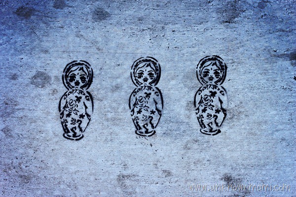 Russian nesting dolls stenciled on the sidewalk.