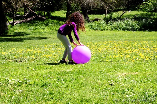 Little girl playing ball in the park