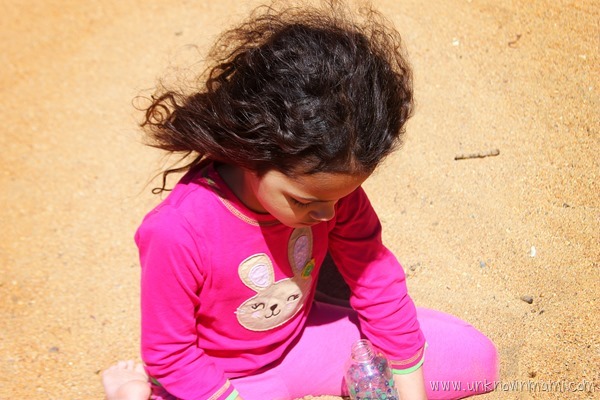 Little girl playing in the sand at Lake Tahoe