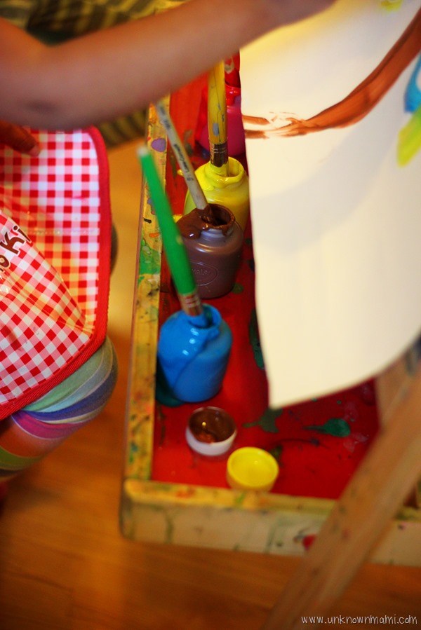 Child painting on easel