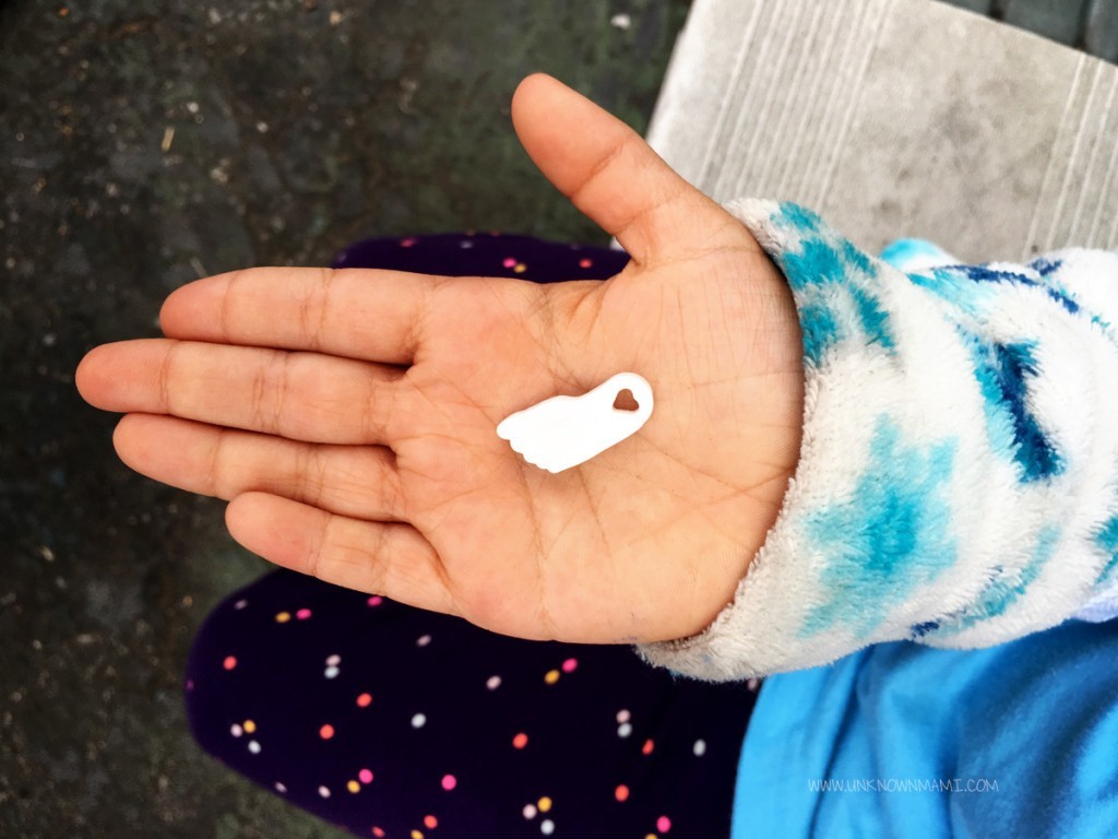 Child's hand with foot charm