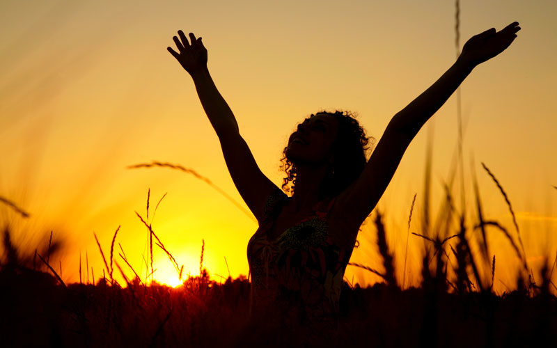 Female silhouette giving thanks