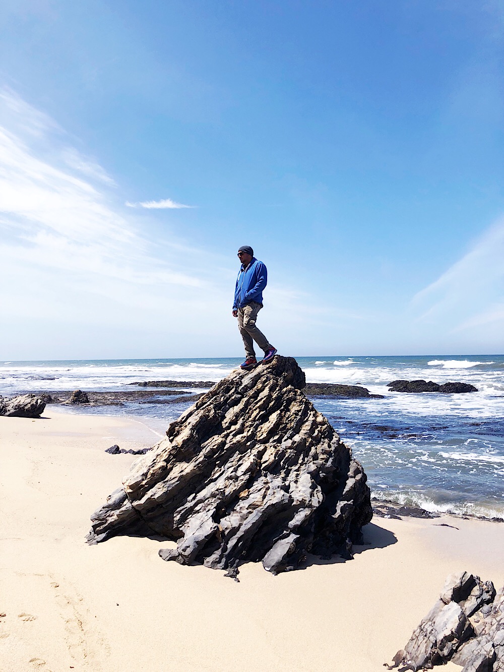 Man on rock at the beach