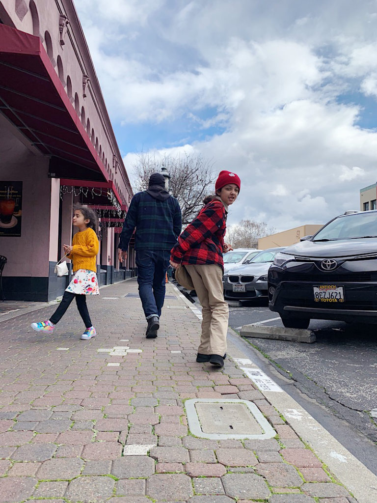 Two girls and their father walking in Redwood City