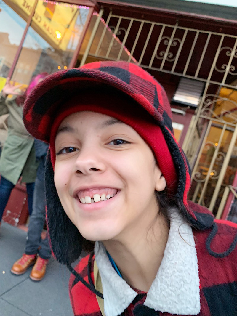 Little girl wearing plaid hat