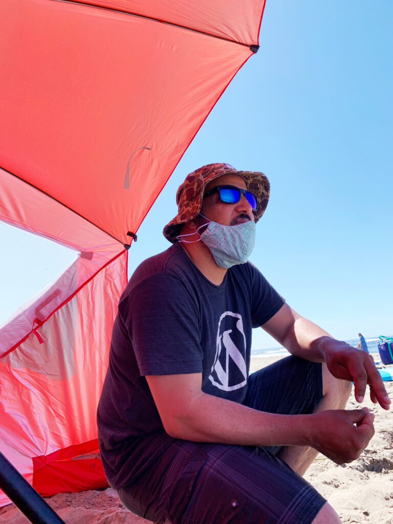 man at beach with face mask